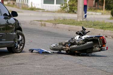 motorcycle on ground after a common cause of motorcycle accidents